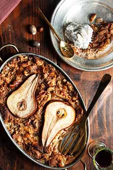 An oval baking pan of fresh-from-the-oven pear bread pudding