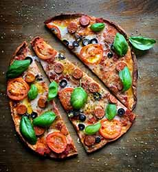 Pepperoni-olive-tomato-basil pizza with a drizzle of EEVO