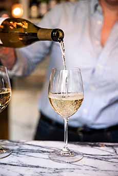 Pouring a glass of Sekt.