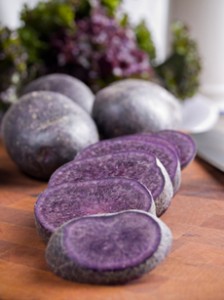 Purple potatoes on a cutting board