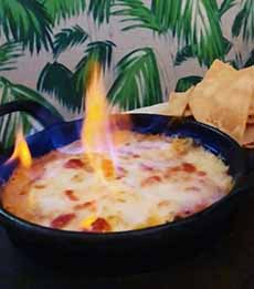 Queso Flameado, flambeed queso dip, in a skillet