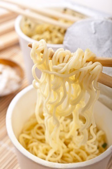 ramen noodles raised on chopsticks