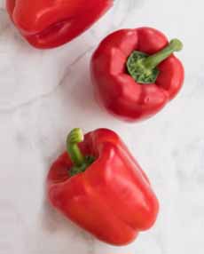 Three Red Bell Peppers, ready to slice