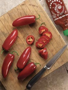 Red Jalapeno Chiles On A Cutting Board