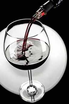 Pouring a glass of Carignan red wine.
