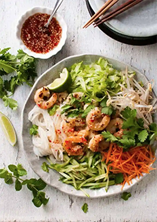 A bowl of Vietnamese rice noodle salad with grilled shrimp.