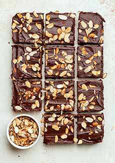 A pan of Amaretto Brownies with almonds sprinkled on top