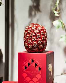 Rubyglow Pineapple Atop Its Special Box