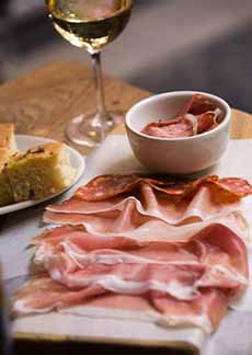 A Platter Of Prosciutto & Salume With A Glass Of Riesling