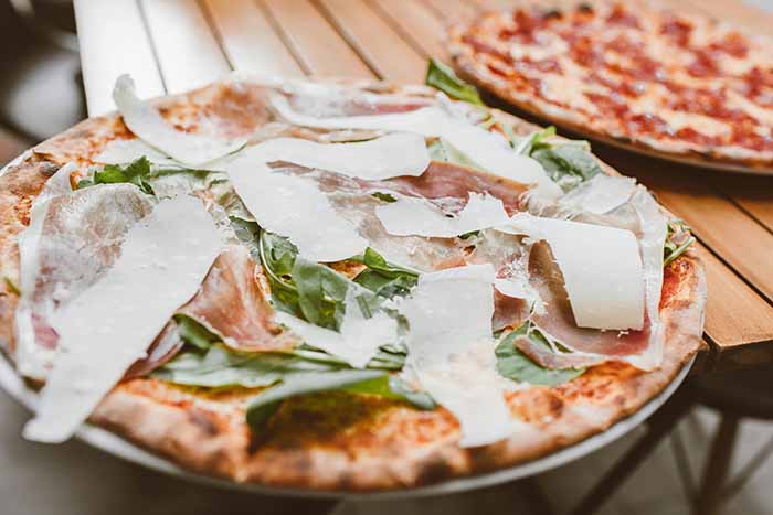 Pizza Topped With Arugula & Shaved Parmesan