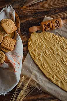 Springerle cookie dough rolled out, with the baked cookies.