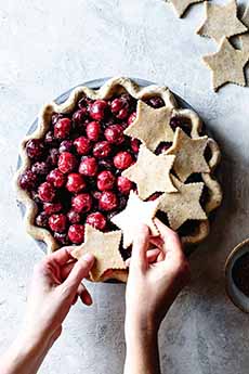 Unbaked cherry pie with star cutouts crust