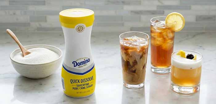 A Package Of Domino Superfine Sugar With Drinks