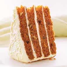 A slice of a four-layer carrot cake with cream cheese frosting and filling.