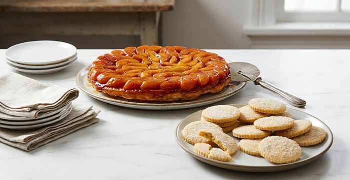 A Tarte Tatin and a plate of French sable cookies.