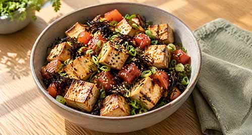 A vegan poke bowl with tofu cubes.