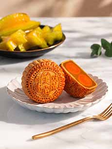 A traditional mooncake with a duck egg yolk, shown whole and halved.