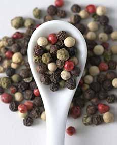 Four Colors Of Peppercorns On A Spoon