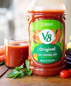A bottle and a glass of V8 Vegetable Juice