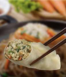 Chopsticks holding a Korean dumpling